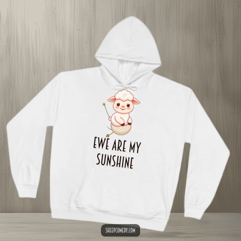 Funny Sheep Hoodie: A happy sheep takes a gentle ride on a floating dandelion, perfect for cozy laughs.