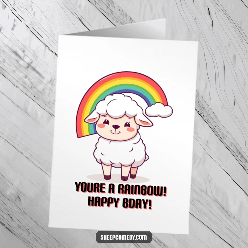 Funny Free Printable Birthday Card: Goofy sheep with a big grin balancing a vibrant rainbow on its back.