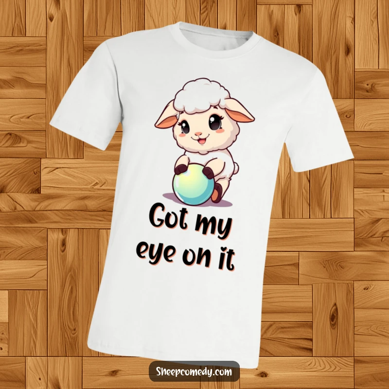 Funny Sheep T-Shirt: A sheep character with an ecstatic expression is actively playing with a bright, shiny ball.